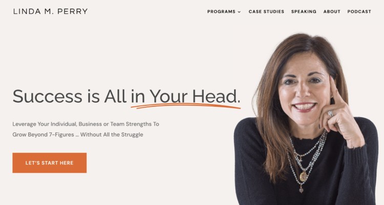 Linda M. Perry smiling and pointing to her temple next to the tagline “Success is All in Your Head,” representing her successful coaching approach.