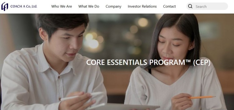 Two individuals reviewing materials together as part of the Core Essentials coaching program offered by COACH A Co., Ltd.
