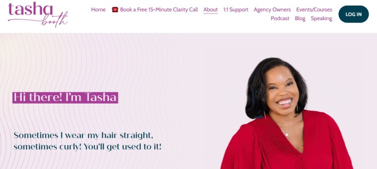 Tasha Booth smiling confidently, known as one of the top female business coaches helping entrepreneurs grow