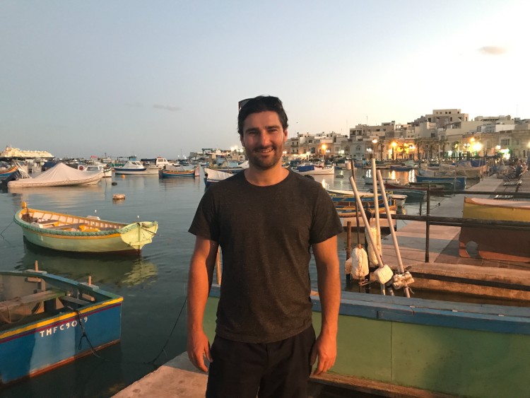 Entrepreneur standing by a harbor at sunset, symbolizing the freedom and flexibility achieved when you start a business