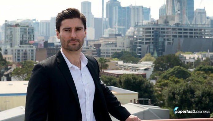 Entrepreneur Liam Austin in a city setting, representing highly effective strategies for building an online coaching business.