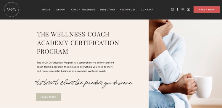 Website banner showing the Wellness Coach Academy Certification Program with a woman holding a mug, highlighting the coaching career path.