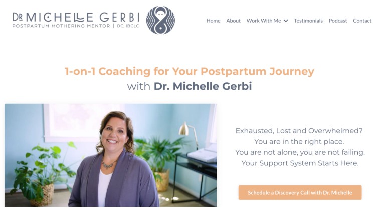 Dr. Michelle Gerbi smiling in her coaching office, offering postpartum mentoring to help you make confident steps through your motherhood journey.
